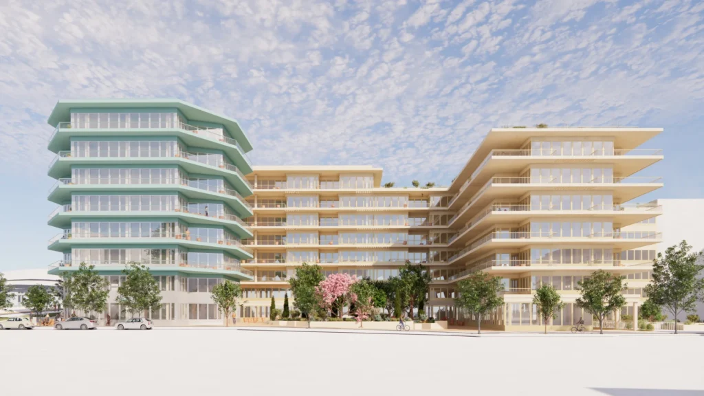 Bâtiment turquoise hexagonal et immeubles beiges modernes avec balcons entourés d'arbres sous un ciel bleu.