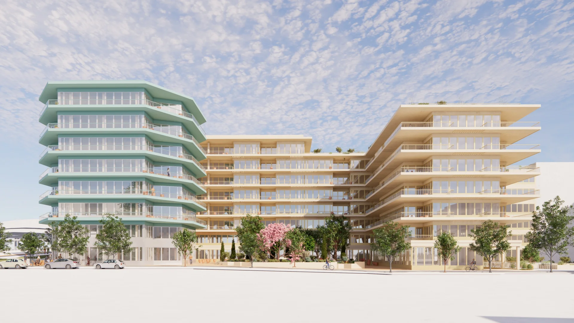 Bâtiment turquoise hexagonal et immeubles beiges modernes avec balcons entourés d'arbres sous un ciel bleu.