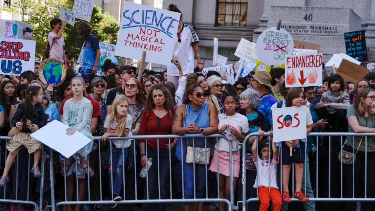 Une foule diversifiée de citoyens rassemblée derrière des barrières, avec une pancarte centrale indiquant 'Science not magical thinking', illustrant l'engagement public pour la science.