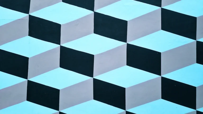 Motif géométrique de cubes en trois dimensions aux tons bleus et gris, style art optique.