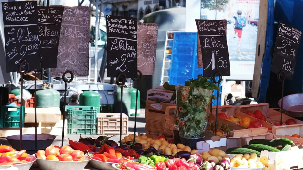 Étal de marché avec des prix affichés pour illustrer les bonnes affaires en centre-ville de Perpignan.