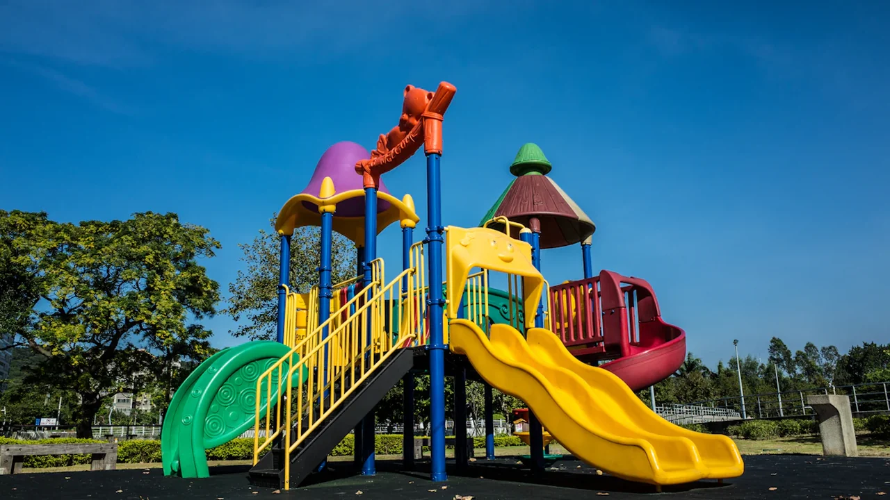Aire de jeux colorée et moderne récemment rénovée avec un toboggan au square du Manège.