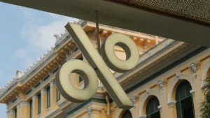 Symbole de pourcentage suspendu devant un bâtiment classique à l'architecture européenne traditionnelle.