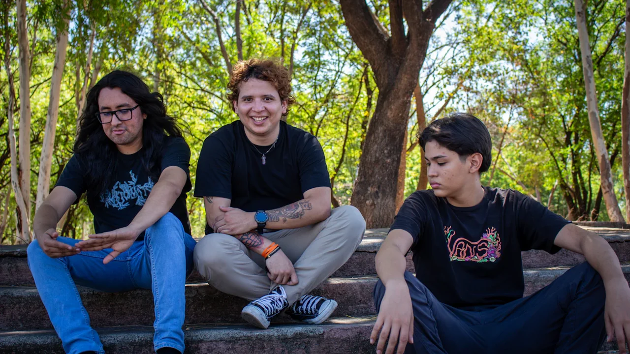 Trois adolescents assis sur des marches d'escalier dans un environnement boisé et ensoleillé.